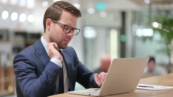 Businessman with Laptop at Work Having Wrist Pain 