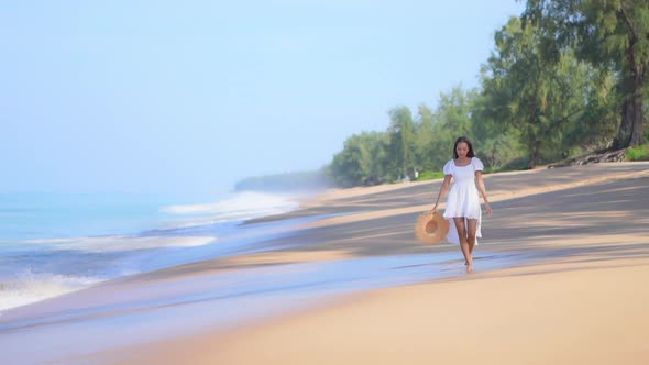 Asian woman enjoy around beautiful beach sea ocean