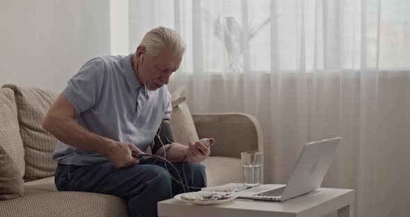 Pensioner Checking Blood Pressure During Video Call