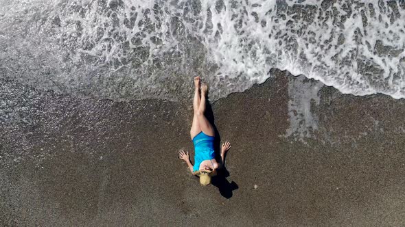 Girl Lying on a Beach in Water, Sunbathing