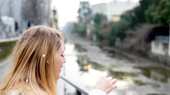 Young woman playing bubble soap