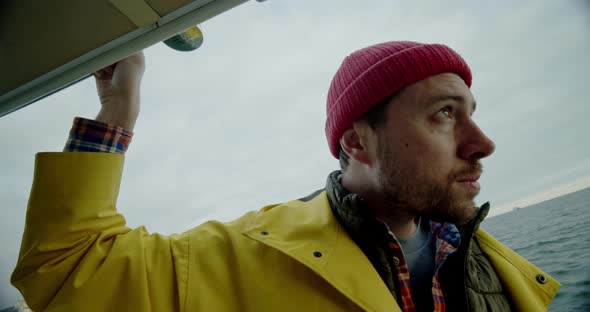 Portrait of Handsome Man Floats on the Ship and Looks Around