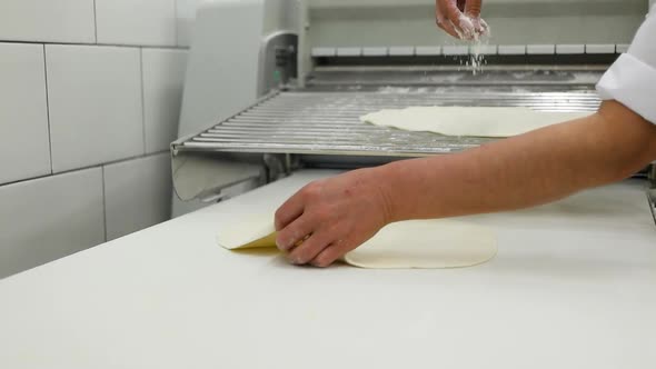 Closeup of Baker Pours Flour in Kitchen