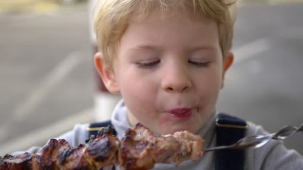 3 Years Old Boy Eats Shashlik Skewer.