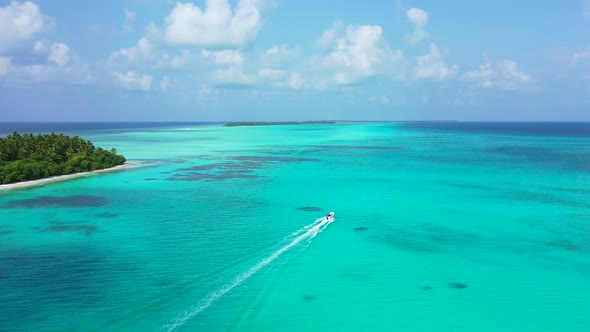 Luxury above abstract shot of a white sand paradise beach and blue ocean background in 4K