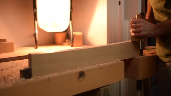 Carpenter Planing Wood in His Workshop in Slow Motion