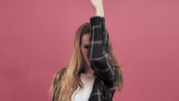 Beautiful Young Woman with Long Hair Having Fun Smiling and Dancing in Studio 