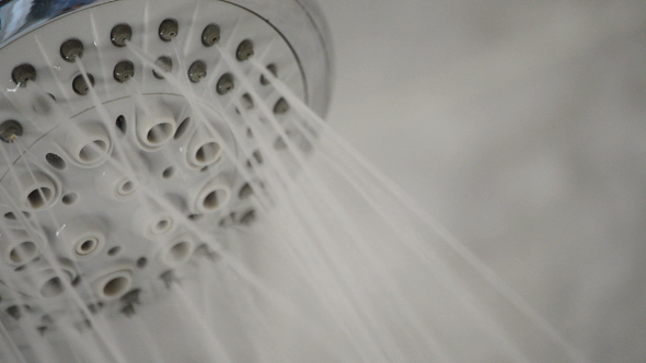 Shower Faucet Expelling Water in a Bath