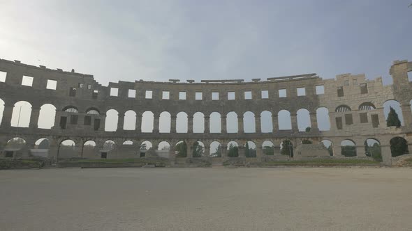 Arches in a stone wall at Pula Arena