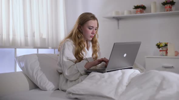 Worried Girl Working on Laptop in Bed Until Morning