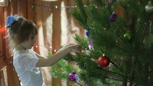 Girl Hanging Toys on the Christmas Tree alt