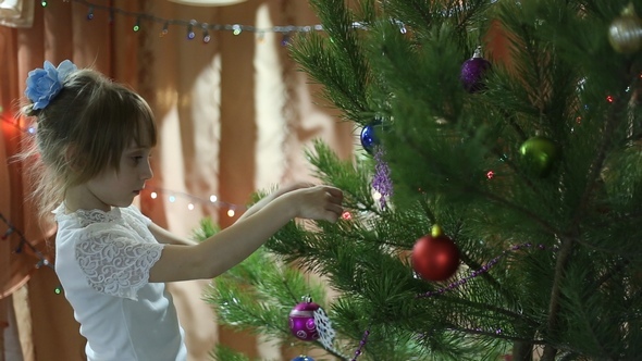 Girl Hanging Toys on the Christmas Tree