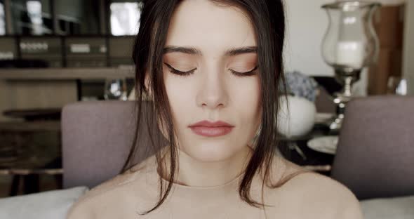 Calm Young Woman Meditating with Her Eyes Closed and Then Opening Beautiful Eyes