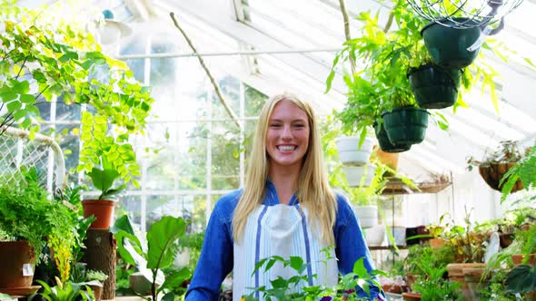 Portrait of beautiful woman carrying flower plant