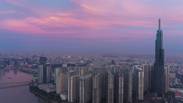 Drone counter clockwise orbit of Central Park development, Landmark, Saigon river and city skyline i