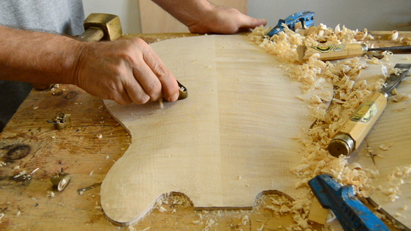 Luthier Working in a Electric Guitar in Workshop