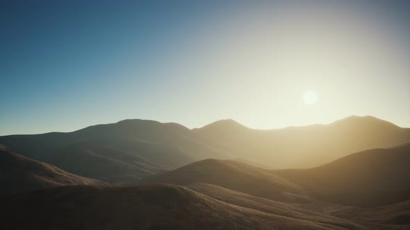 Hills with Rocks at Sunset