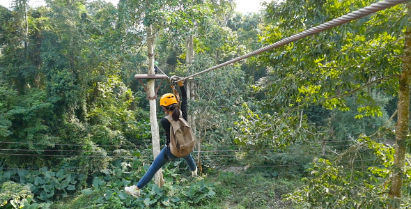 Young Women Sliding On Zip Line