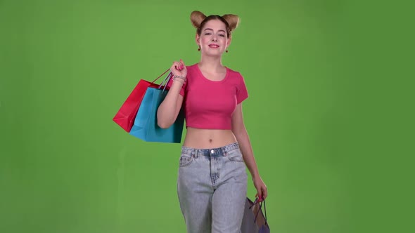 Girl Goes Shopping with Bags in His Hands. Green Screen. Slow Motion