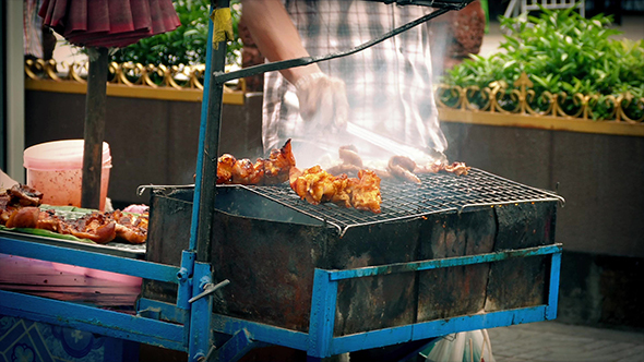 Street Vendor Cooking Meat On Smoking Grill
