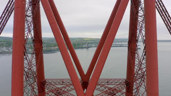 A Commuter Train Crossing a Red Bridge