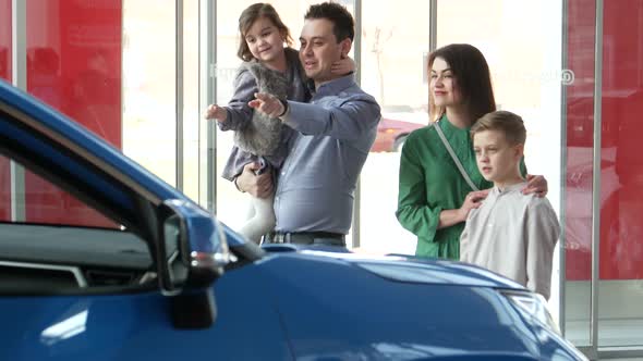 A man gives his wife the keys to a new car, a happy family