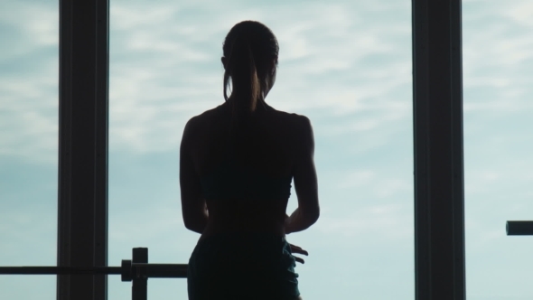 The Woman Shows Muscles In Fitness Hall alt