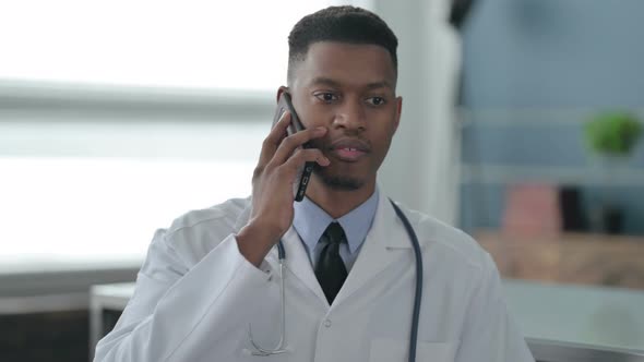 Portrait of African Doctor Talking on Smartphone