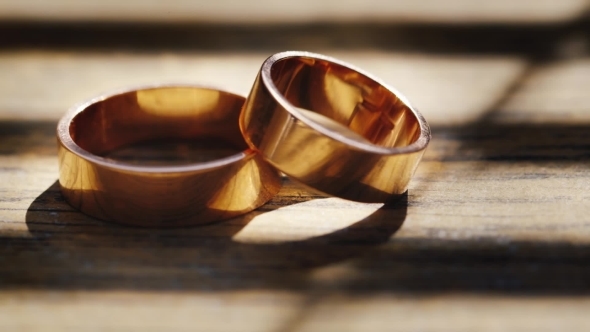 Wedding Rings On a Wooden Texture