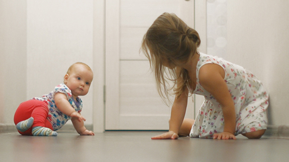 Baby Girl And Little Girl Crawling