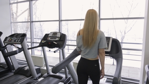 Athlete Sexy Woman Walking On a Treadmill alt