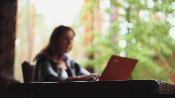 Woman Working On Laptop Bokeh