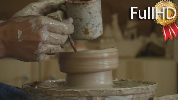 Potter Craftsman is Working on Pottery Wheel