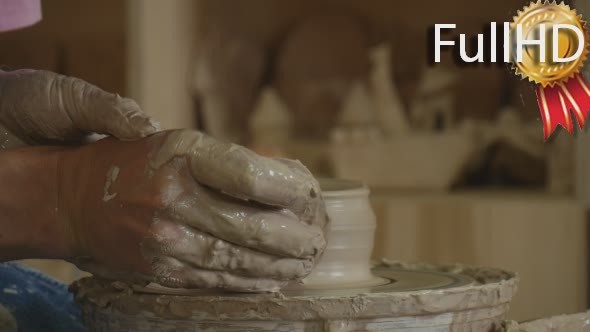 Potter Craftsman is Working on Pottery Wheel