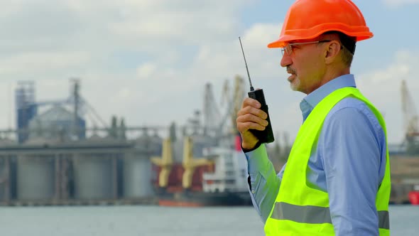 Port Worker at Sea Ships Inspector Talks and Nods Head