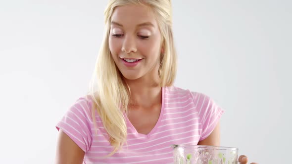 Woman preparing vegetable smoothie