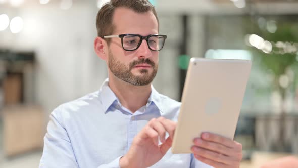 Portrait of Businessman Using Digital Tablet