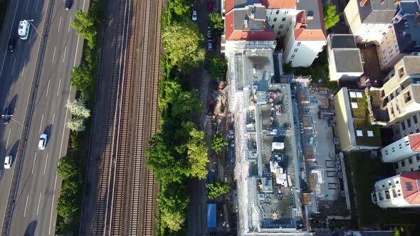 Cars on highway train station Breathtaking aerial view flight drone camera pointing down tilt up dr