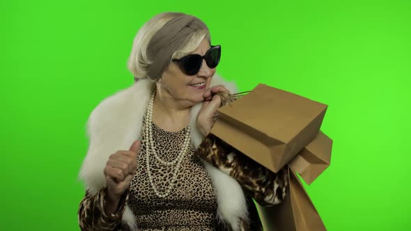 Elderly Stylish Grandmother. Caucasian Woman After Successful Online Shopping