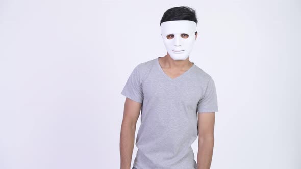 Young Handsome Bearded Indian Man Wearing White Mask