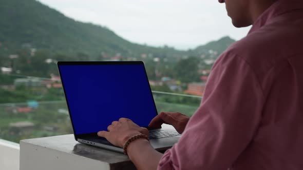 Business Man Freelancer Working at Laptop Computer Outside the Office on the Roof on Background of