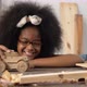 African girl playing with wooden toy car. Carpenter and craftmanship concept. - VideoHive Item for Sale