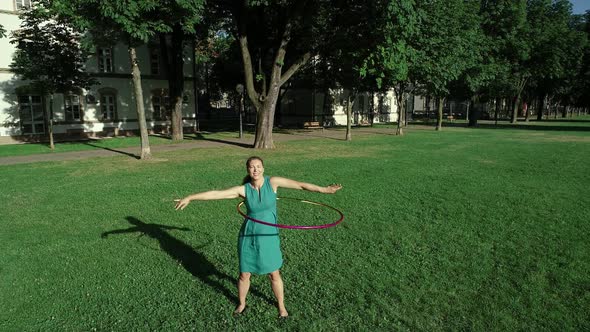 Aerial view of a woman with Hula Hoop in a park, Zagreb, Croatia.