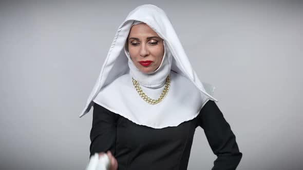 Confident Cheerful Woman in Nun Costume Hanging White Highheels on Shoulder Leaving