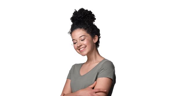 Portrait of Seductive Woman with Curly Hair in Bun Wearing Basic Tshirt Posing at Camera with Hands