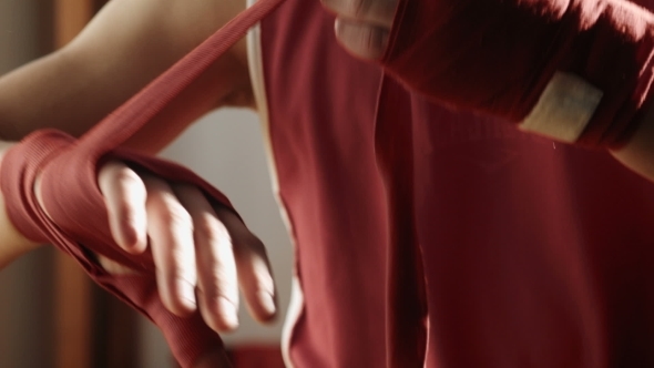 The Young Boxer Pulls Red Bandage On Hands