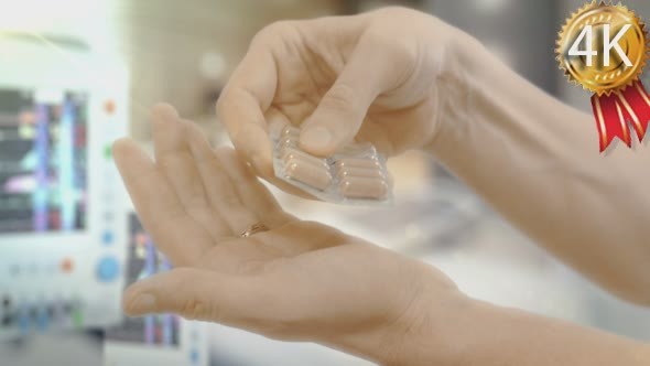 Male Hand is Taking a Medicine Capsule Off The