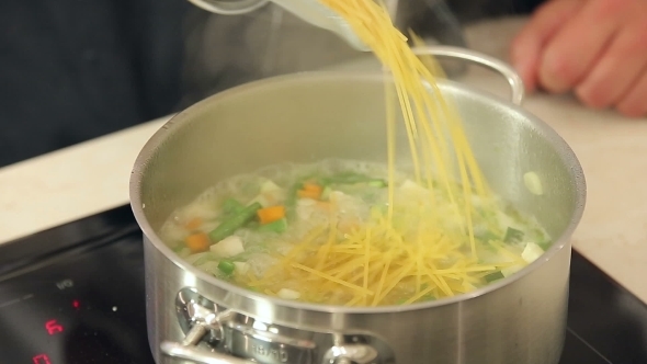 Chef Is Putting Pasta Into a Boiling Pot Of