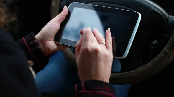 Woman Uses Tablet in the Car