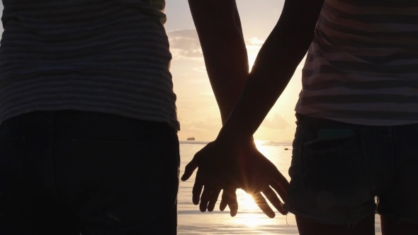 Summer Couple Holding Hands At Sunset On Beach. 